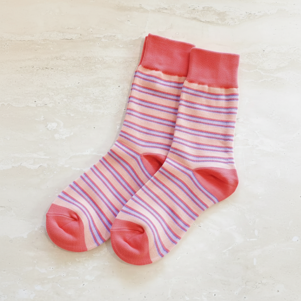 Pink striped socks - cream stone background